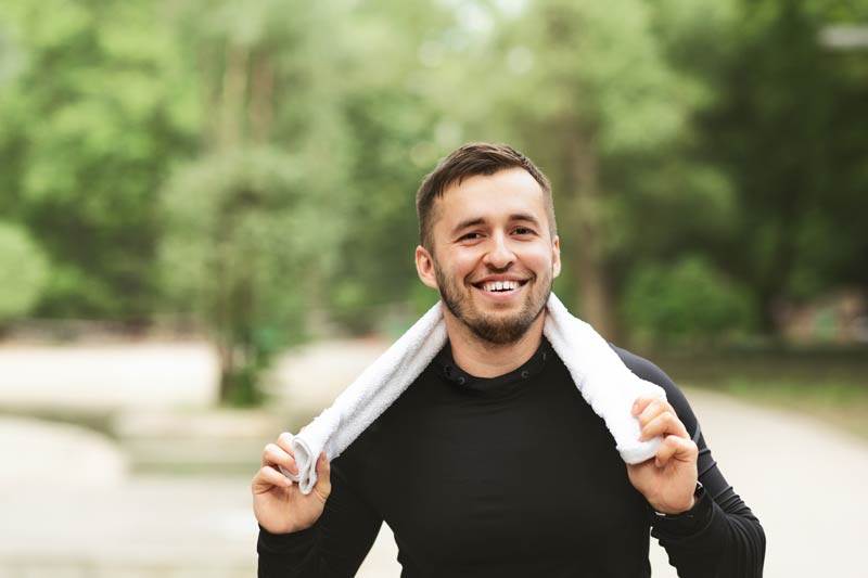 portrait of handsome young athlete with towel